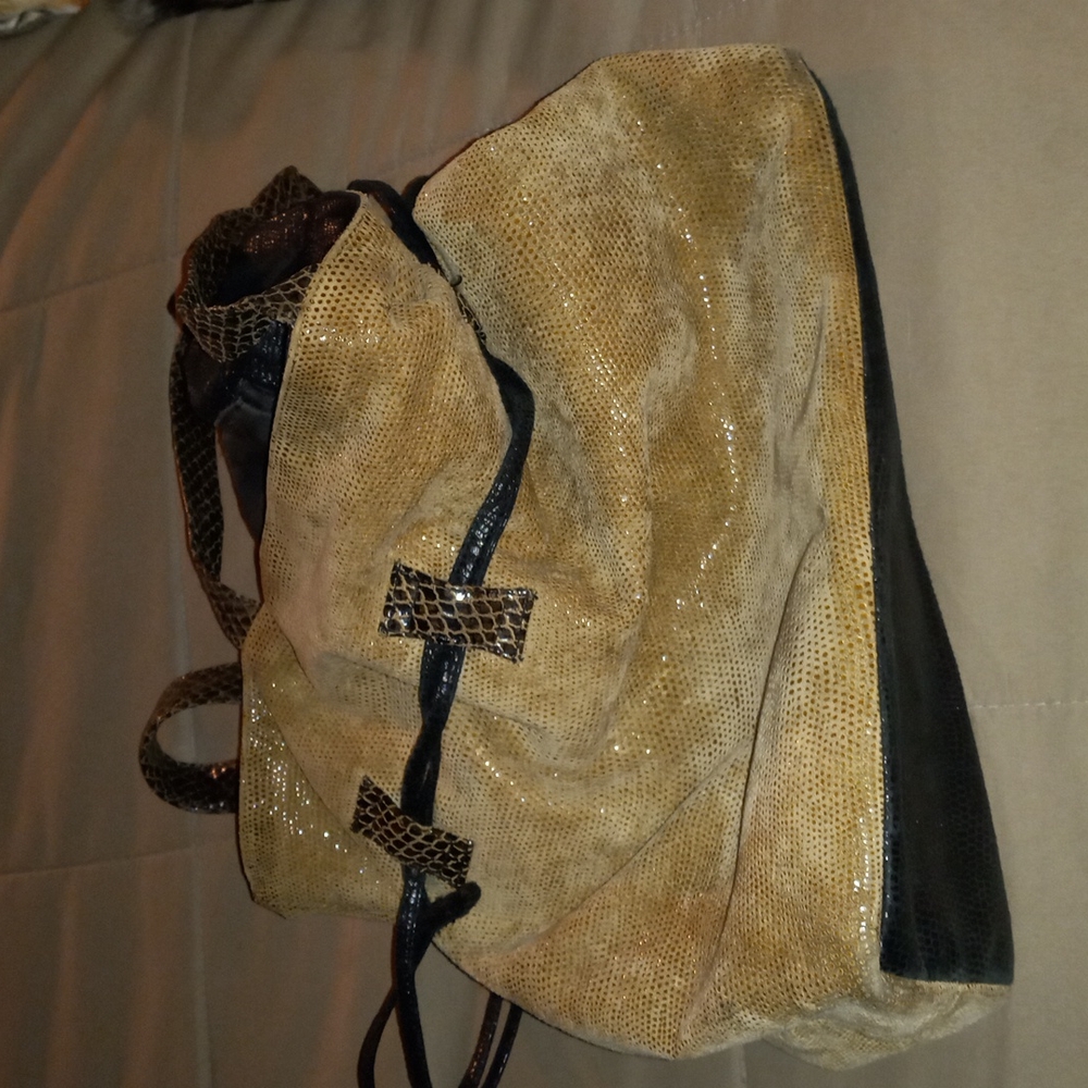 Very soft shimmery shiny  snake like skin looking. Very pretty bag